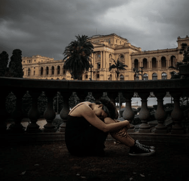 woman sits outside with depression