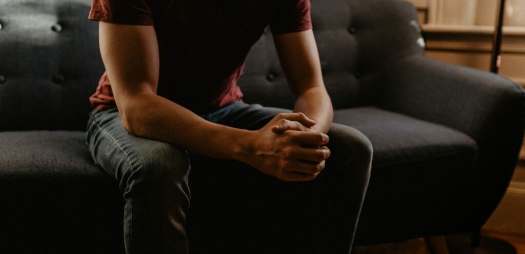 a man sitting down representing how long does it take for alcohol withdrawal symptoms to start.