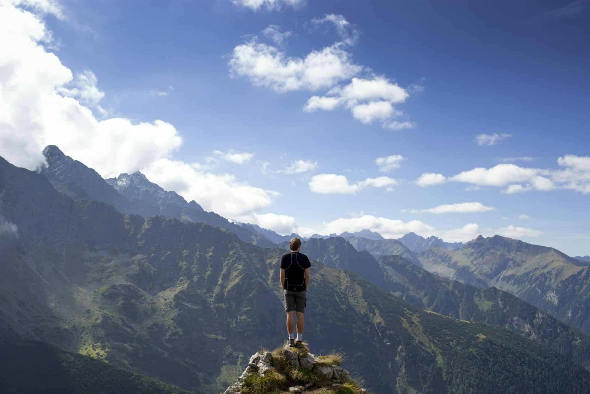 an image of a man on a mountain who learned how to overcome addiction