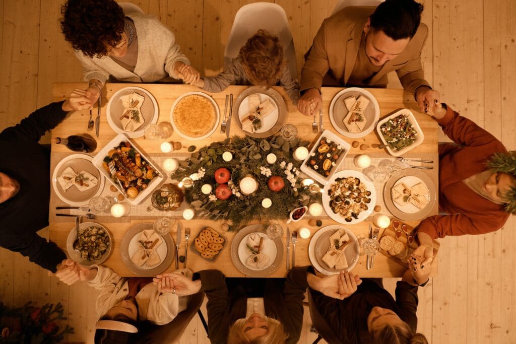 An image of a family at a dinner table during the holidays | How To Get Through The Holidays While in Recovery