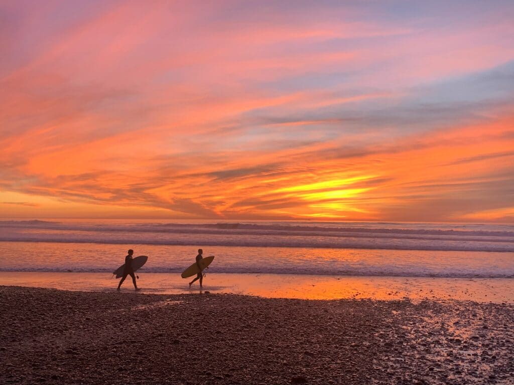 An image of two people on a beach learning about IOP benefits