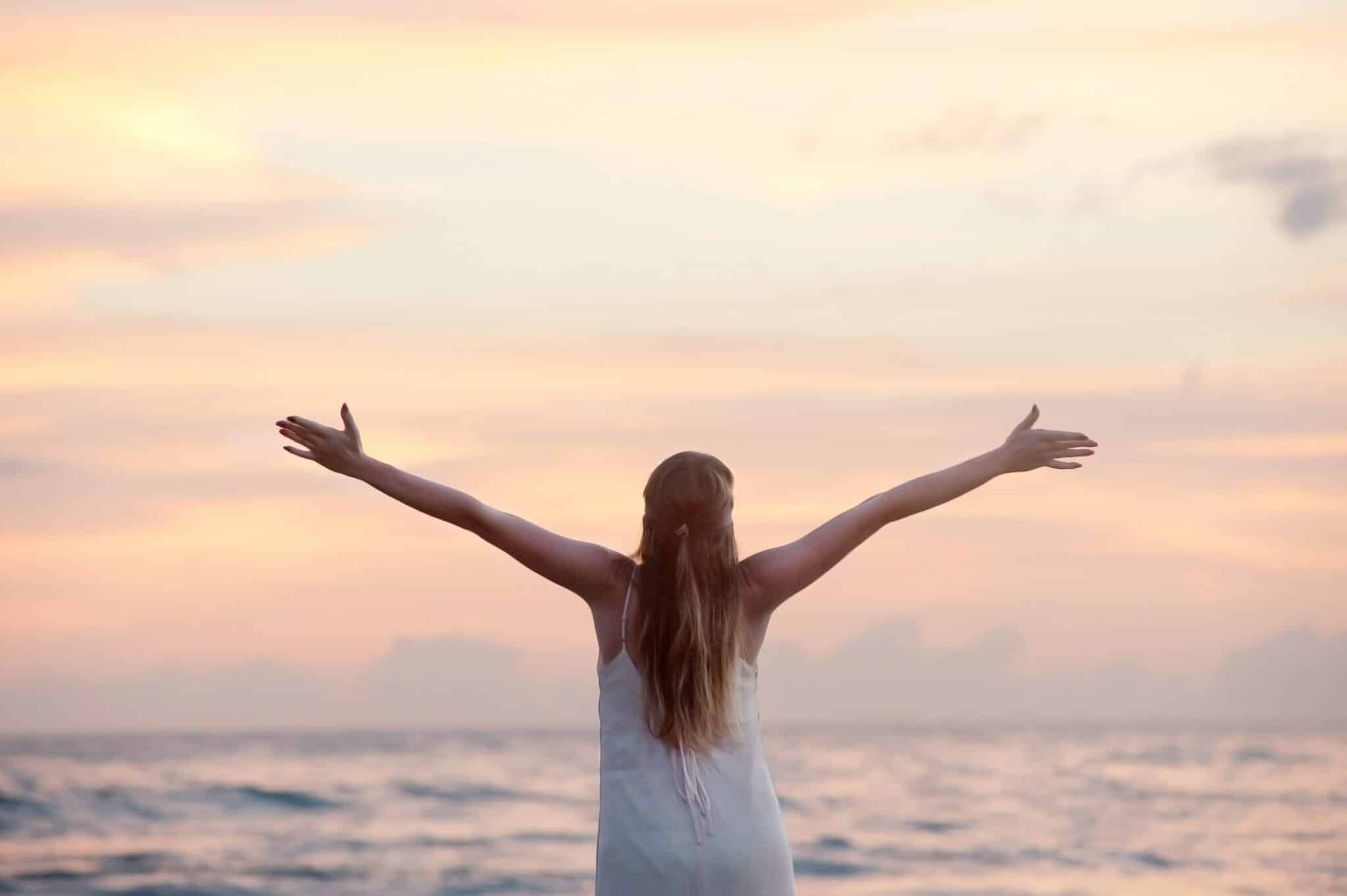 An image of a woman at the beach learning how to stay sober