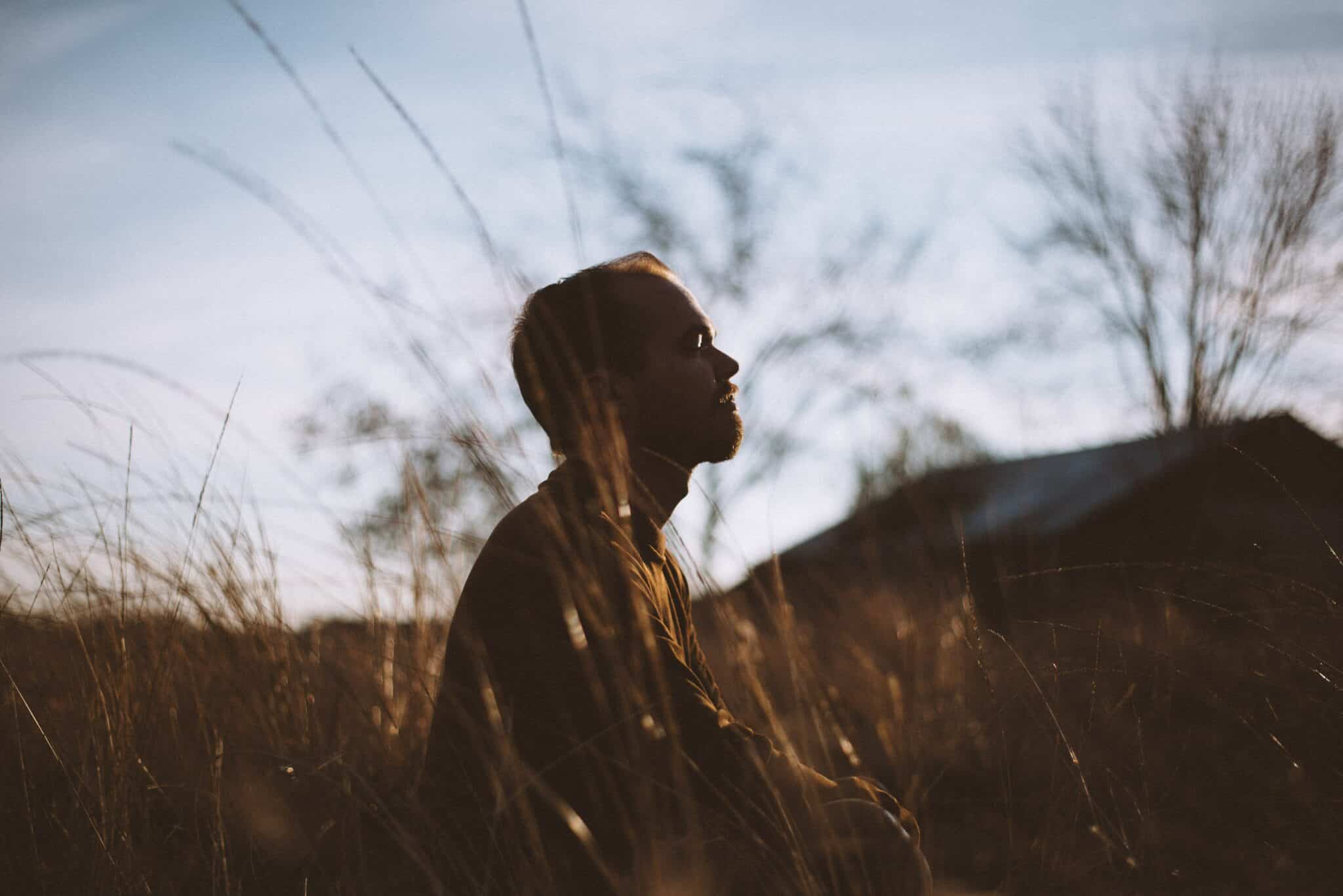 An image of a man in a field | Whippets