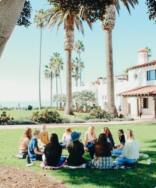 group sitting in a circle in the lawn outside