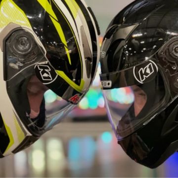 2 people in motorcycle helmets going head to head