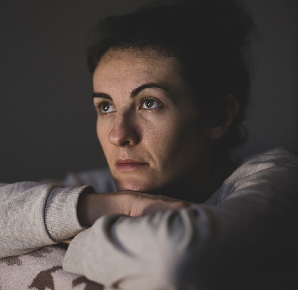 a woman sits with her arms crossed to represent xanax rehab in southern california.