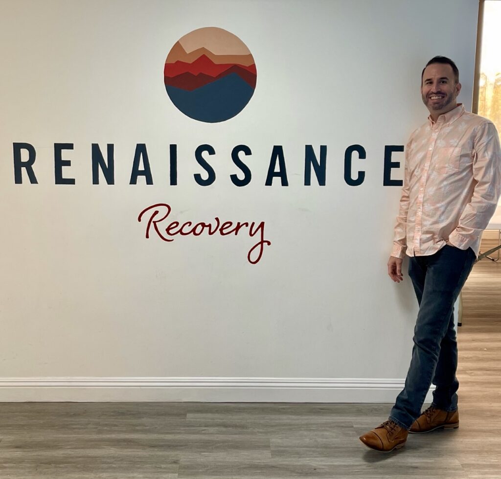 person posing with the renaissance recovery logo