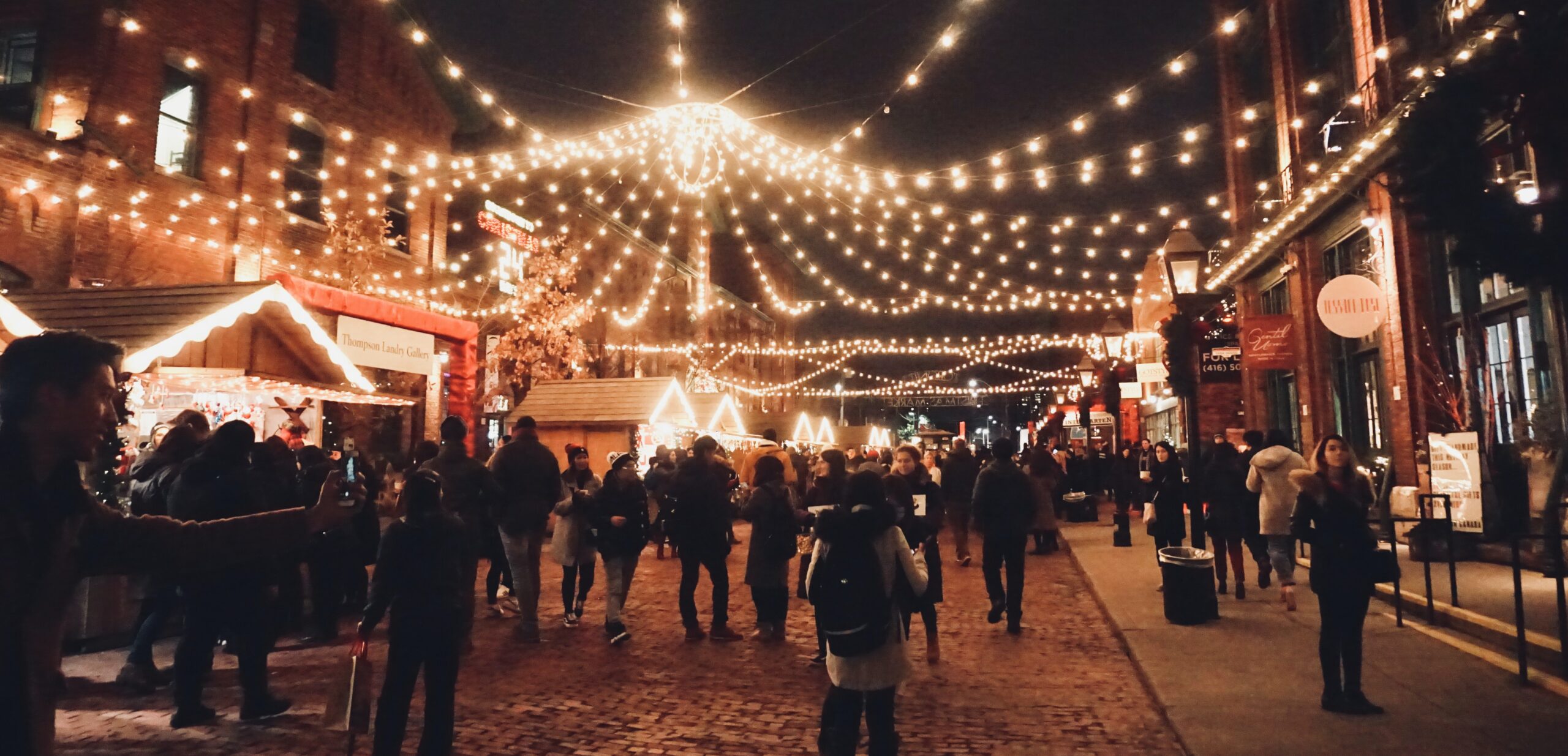 A crowd of people attends a night market at one of the best sober newport beach nightlife activities.