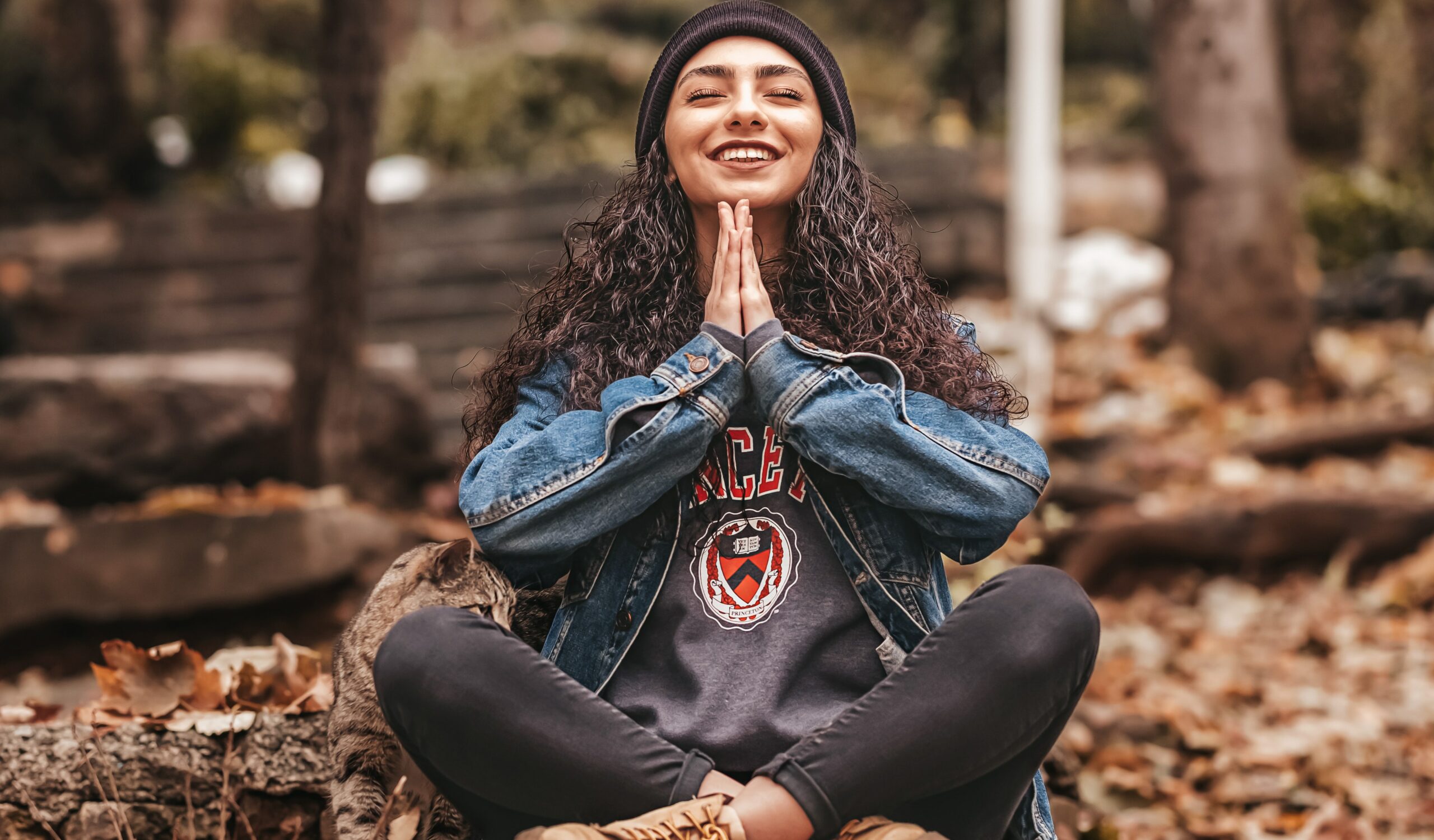 A woman sits in Sukhasana yoga pose, representing Newport beach: best places to meditiate