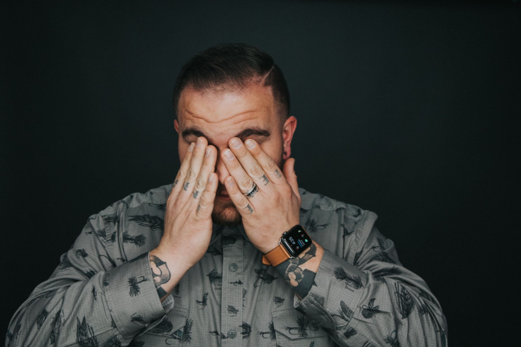 a man has his hands on his face to represent the question: what is black tar heroin?