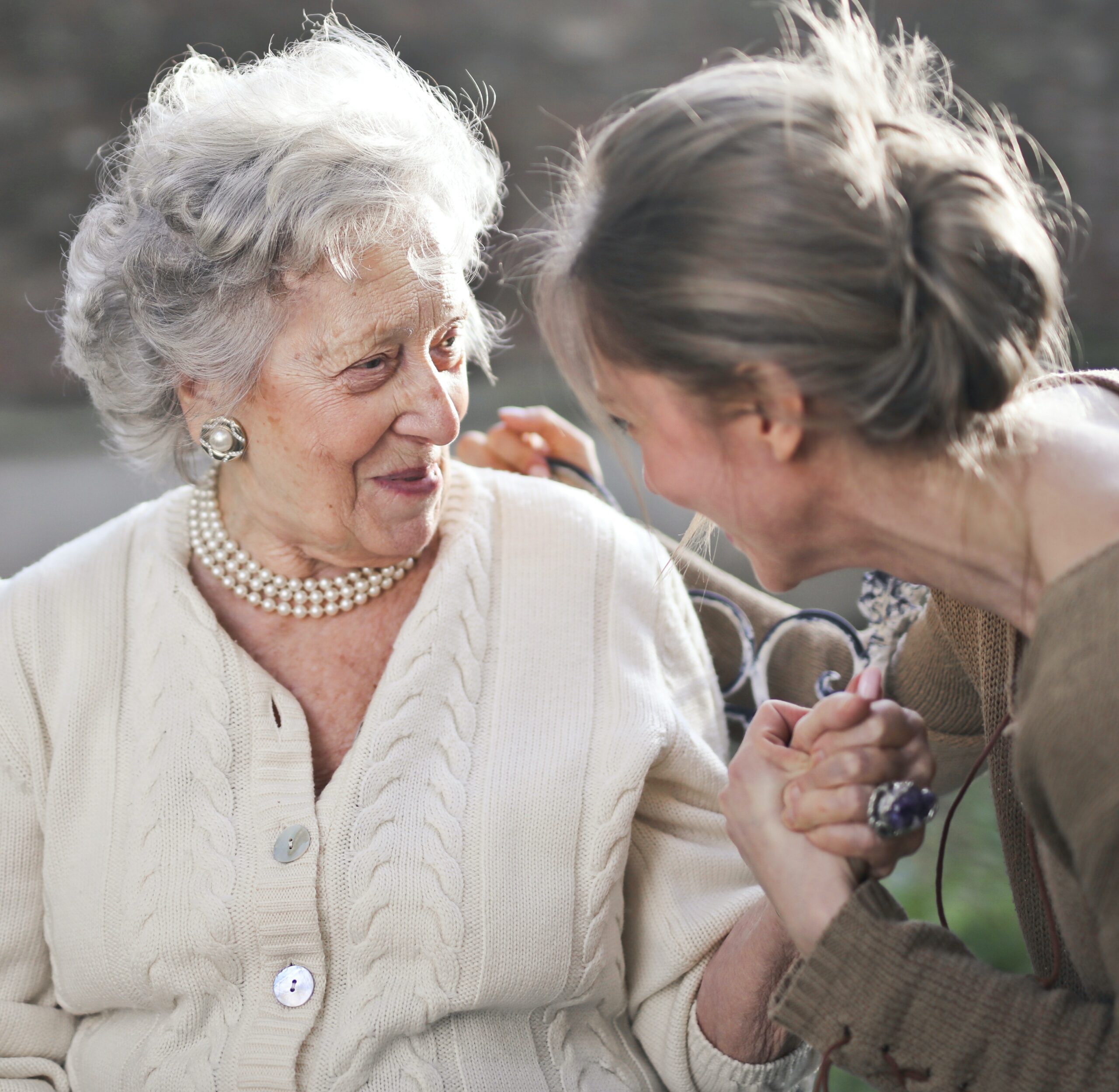 an elderly woman is laughing with a friend to represent xanax side effects in elderly.