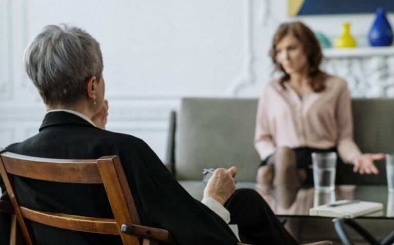 two people sit in a therapy session to represent prescription drug addiction treatment california.