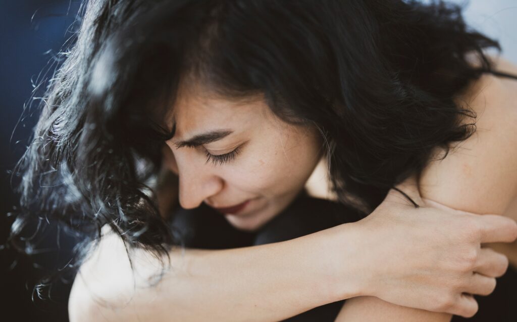 a woman sits with her arms crossed to represent prozac abuse