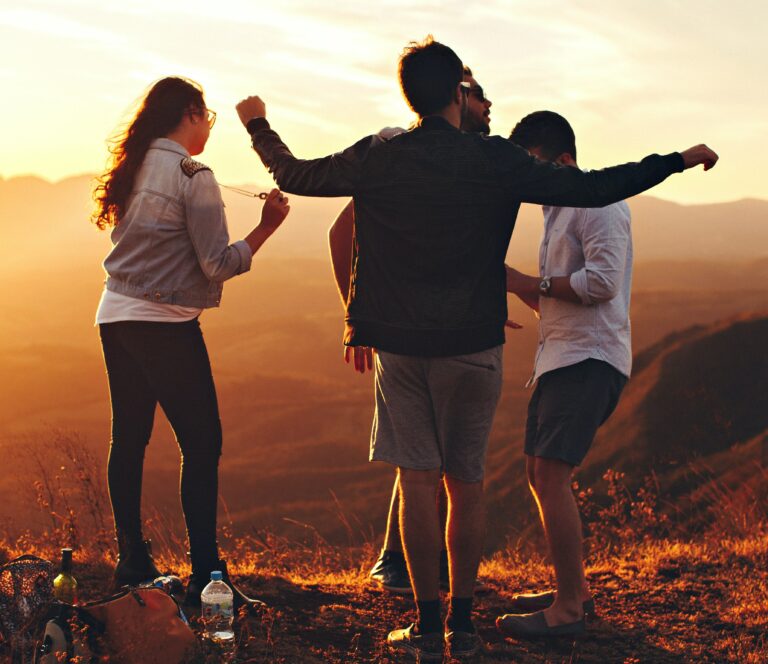 4 people hanging out on top of a hill together