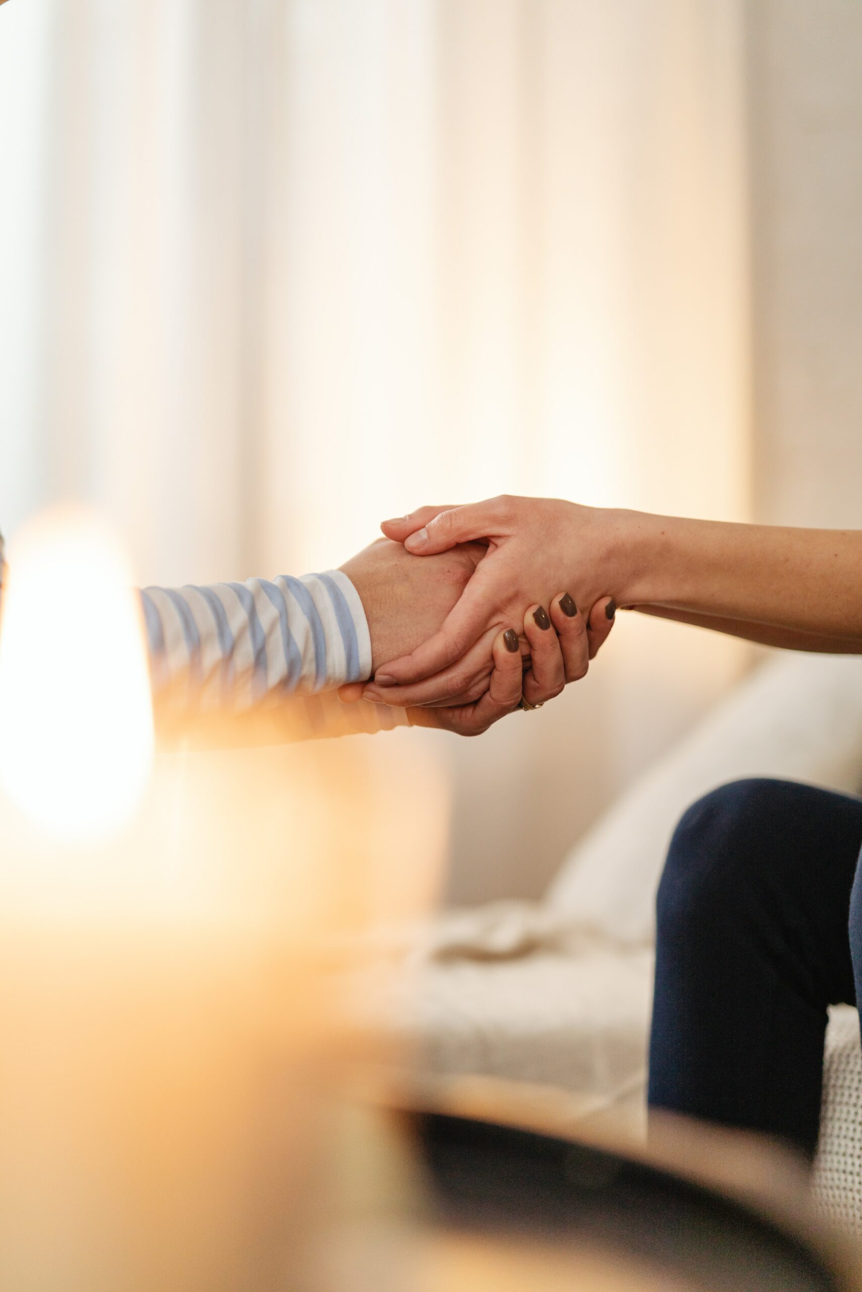 a person holding another persons hands to represent prescription drug addiction treatment.