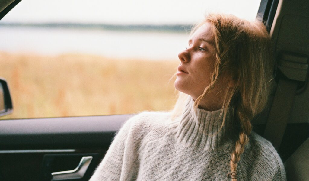 a woman looking out a car window to represent heroin identification for a loved one. 