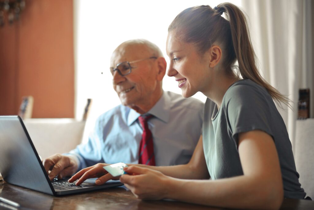 woman and older man on a laptop together