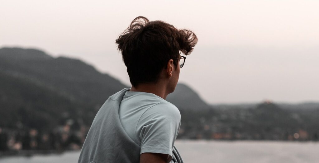 A man looks out at a beach representing gabapentin addiction