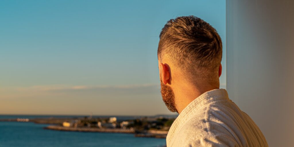 a man looks out at a coastline representing what is farmapram