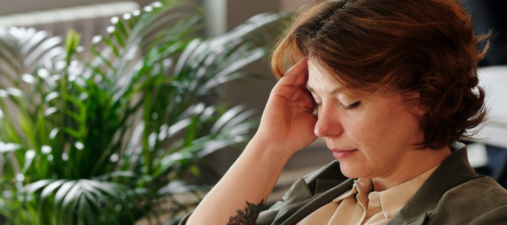 woman with her hand on her face representing vicodin addiction. 