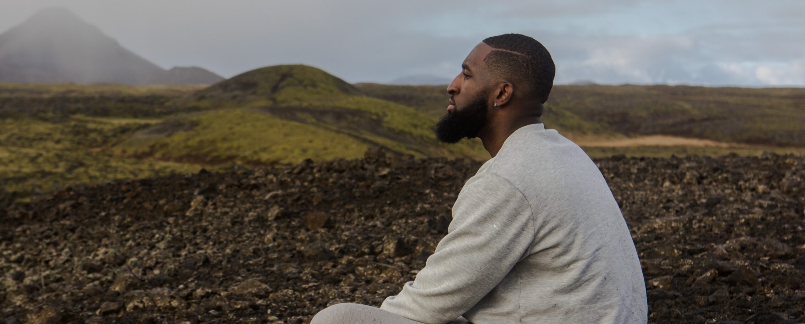 man looks out at scenery representing white oblong pill