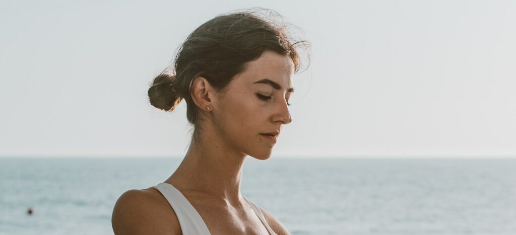 A woman practicing breathwork therapy.