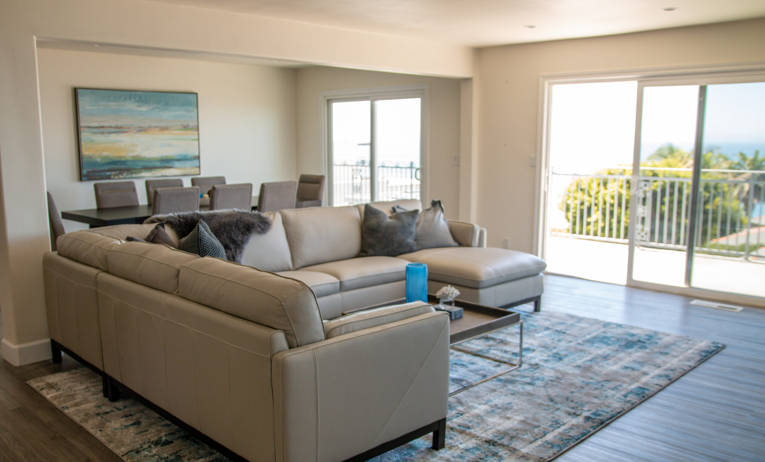 living room with a couch and dining room behind it