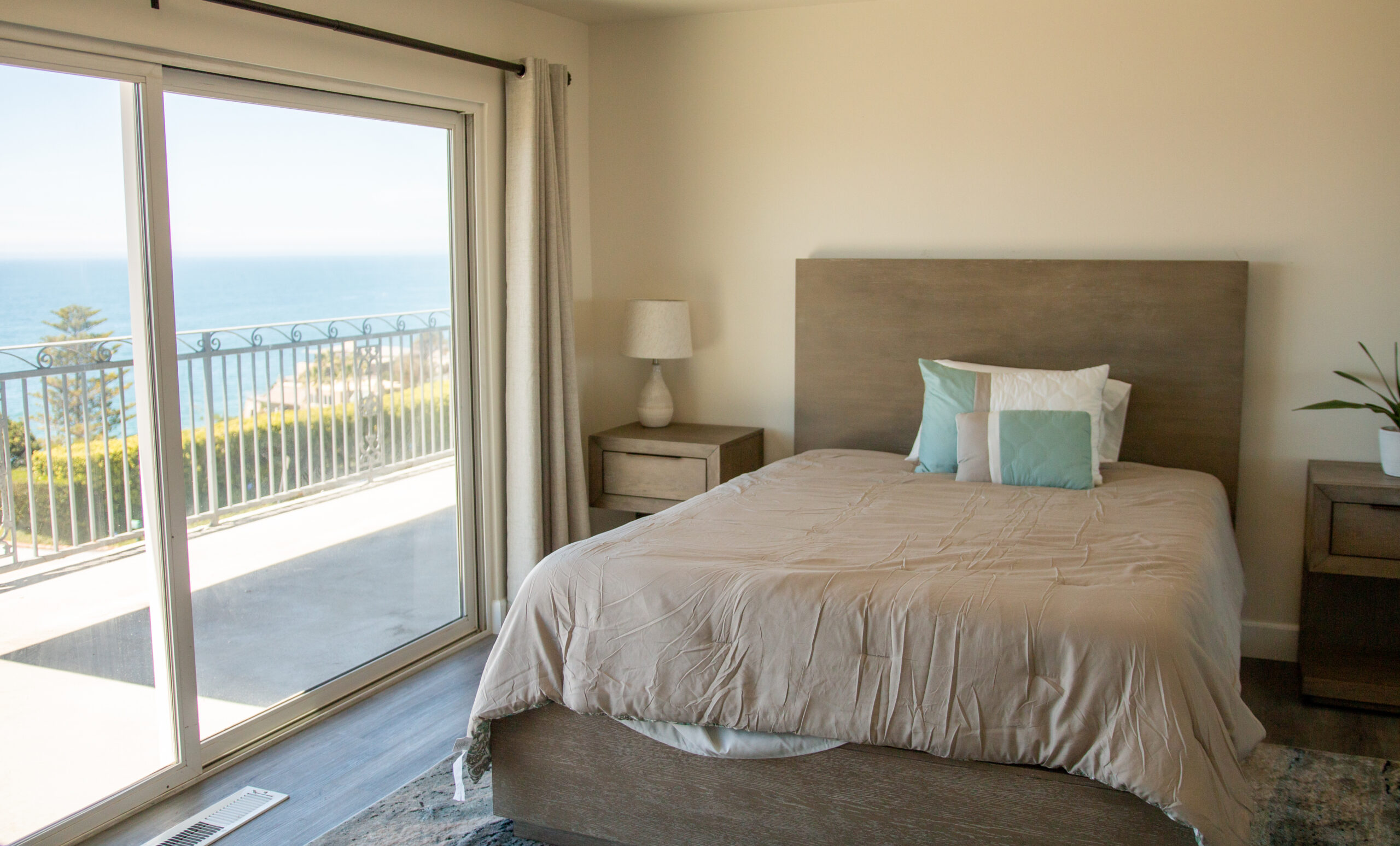 bed in a room next to a sliding glass door