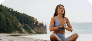 woman doing yoga on the beach