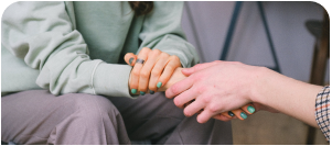 two people holding hands representing hug an alcoholic