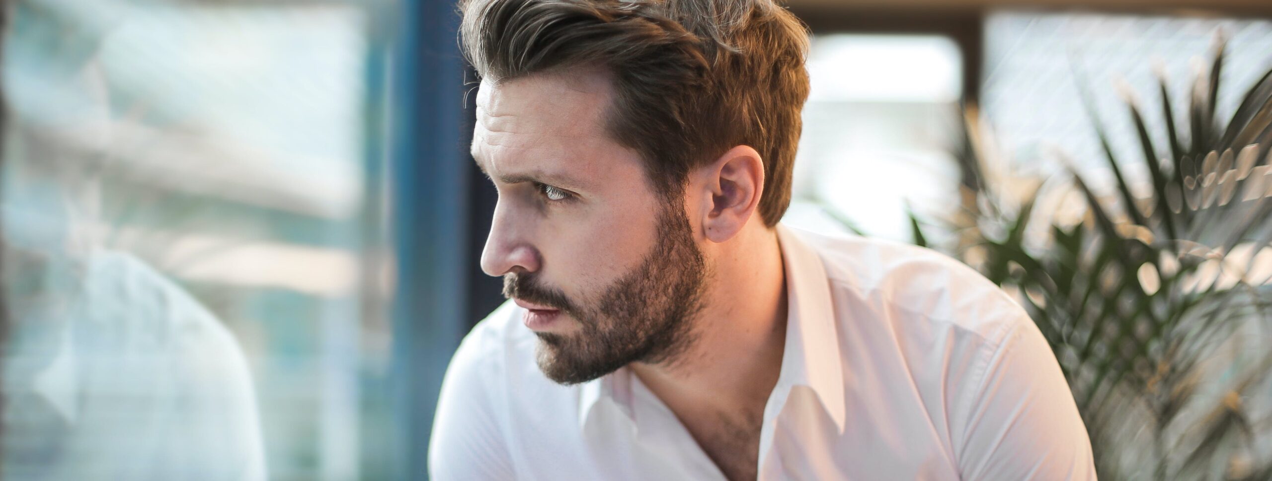 man looking out window representing how addictive is ketamine