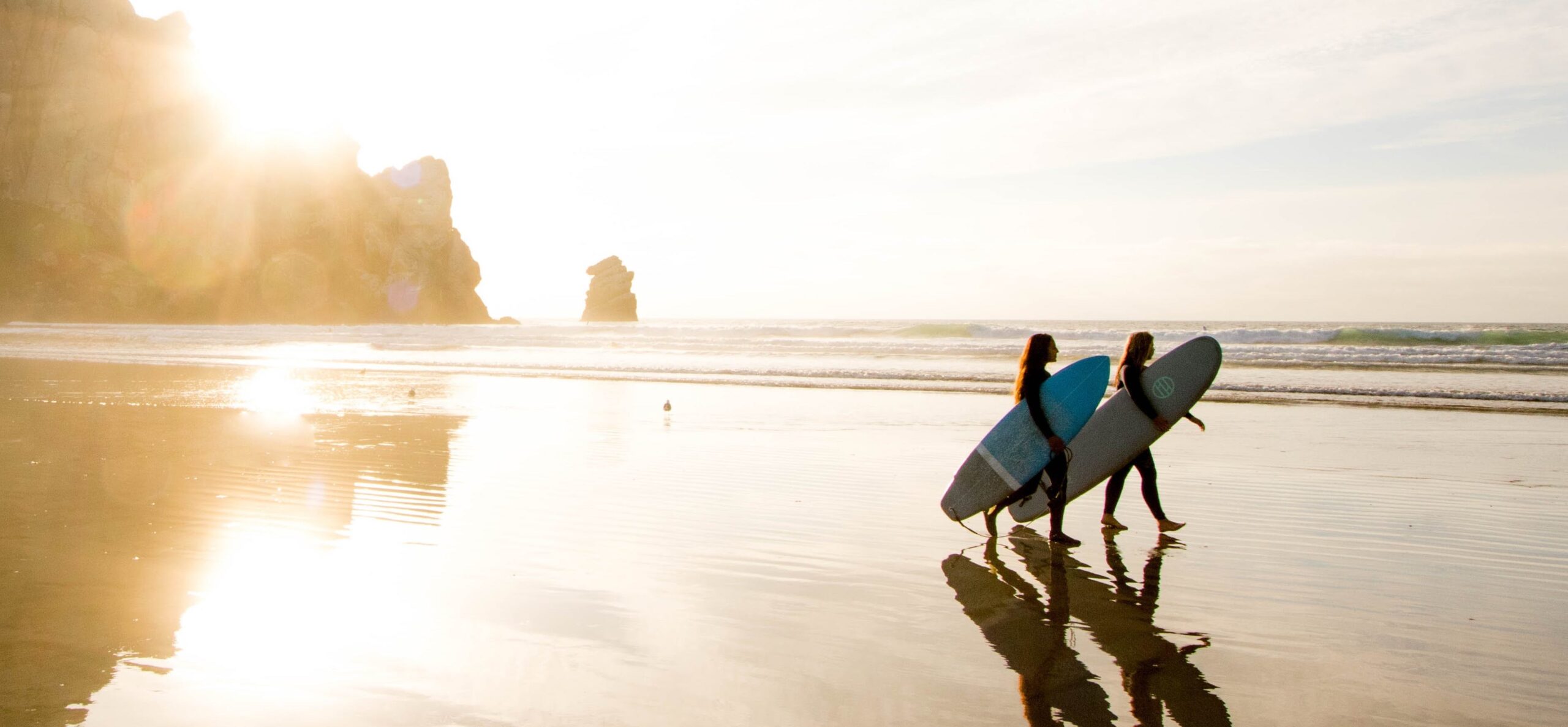 people on beach with surfboards representing Drug rehab california