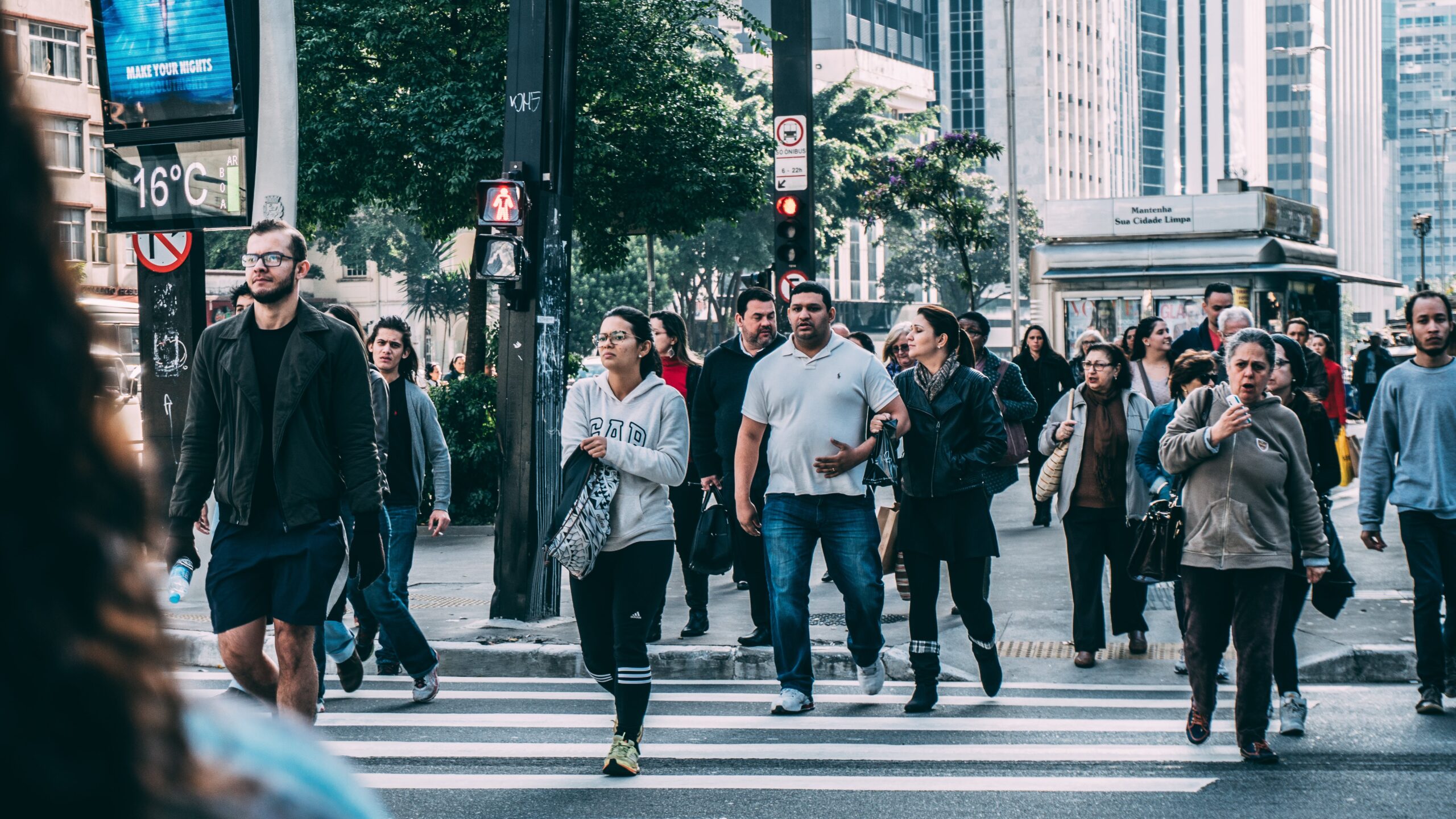 An image of a people walking across a sidewalk, depicting the large population and National Drug & Alcohol Addiction Statistics