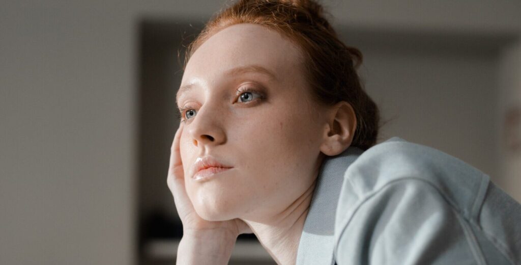 A woman sitting in deep thought, representing the question what is nitazene