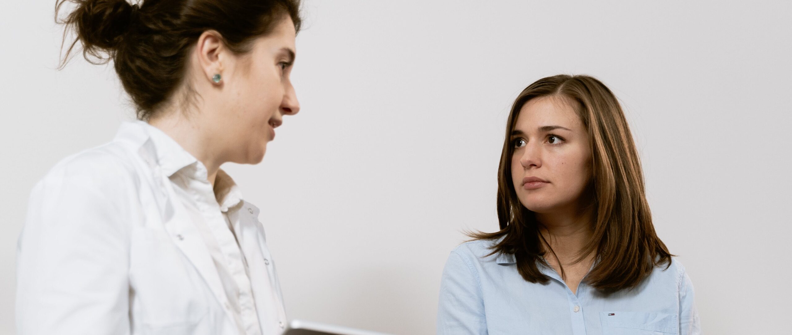 woman talking to dr representing representing heart damage from alcohol