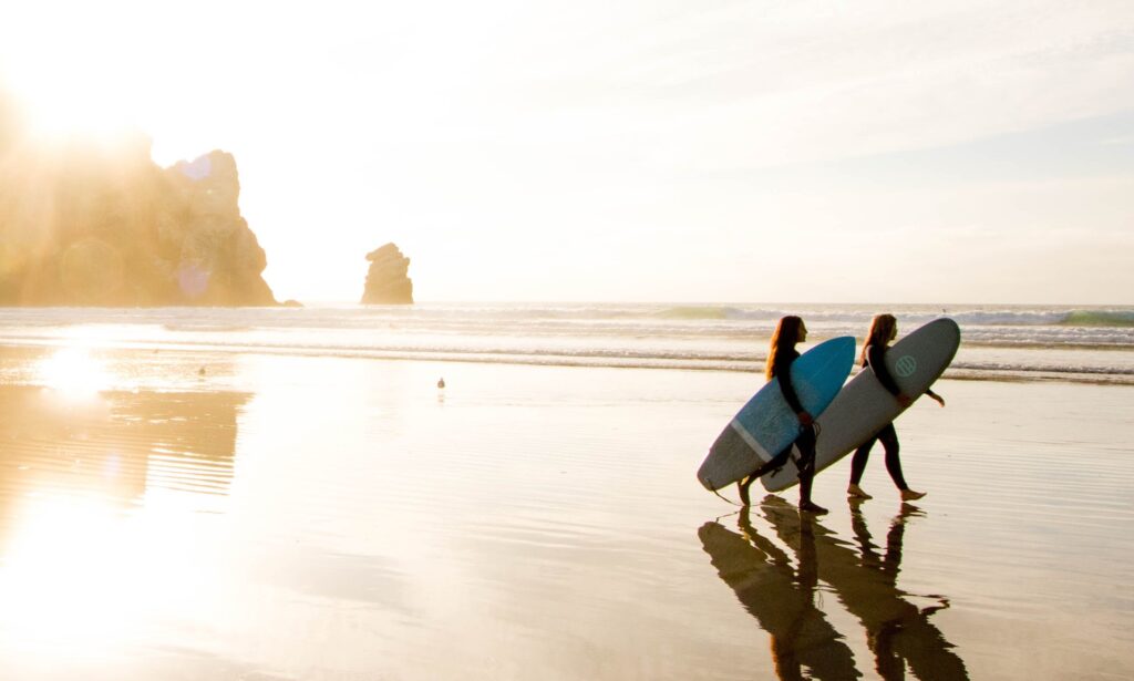 people with surfboards on beach representing santa ana rehab