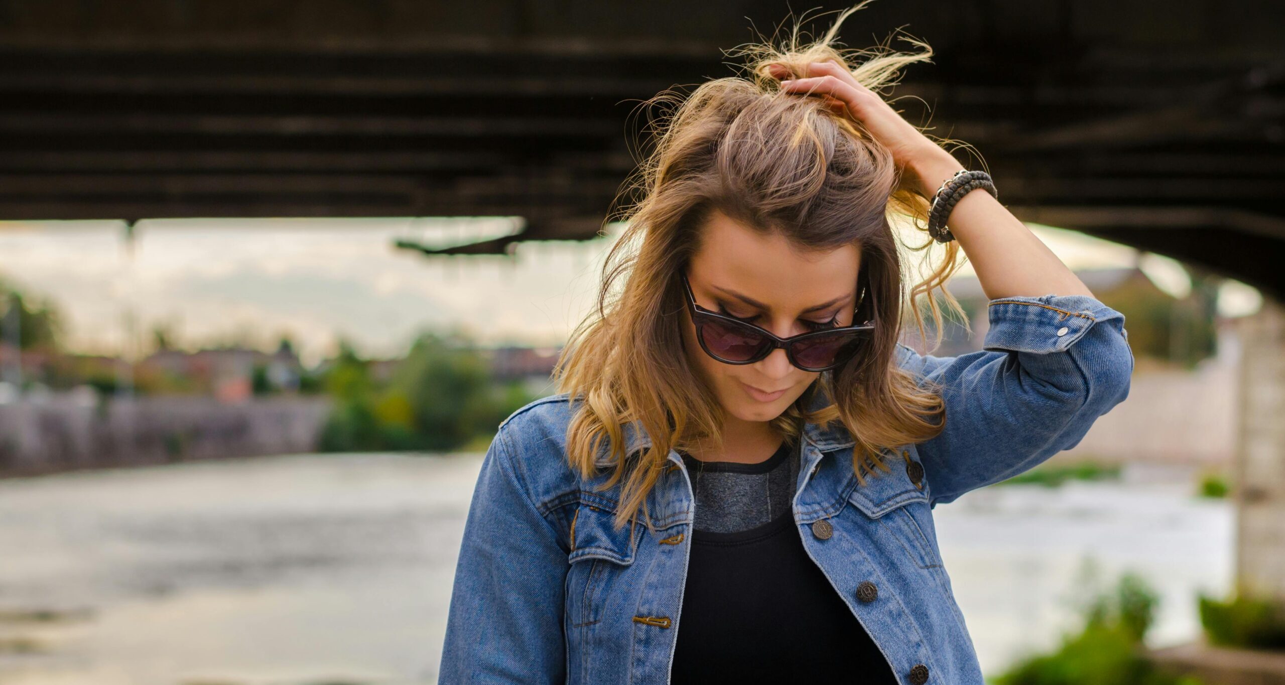 woman with hand in hair representing How soon does alcohol withdrawal start?